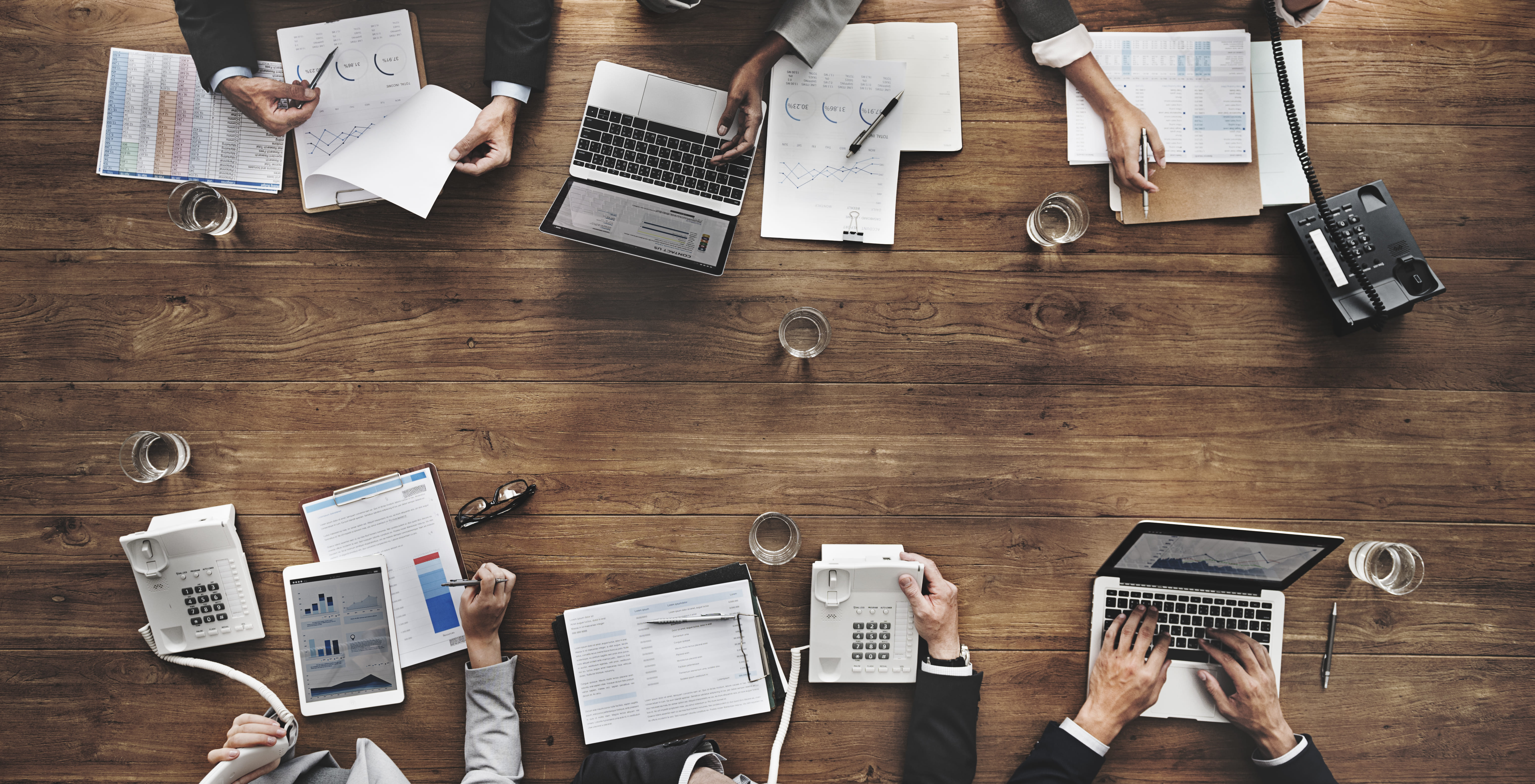 Modern VoIP desk phones in a business conference setting