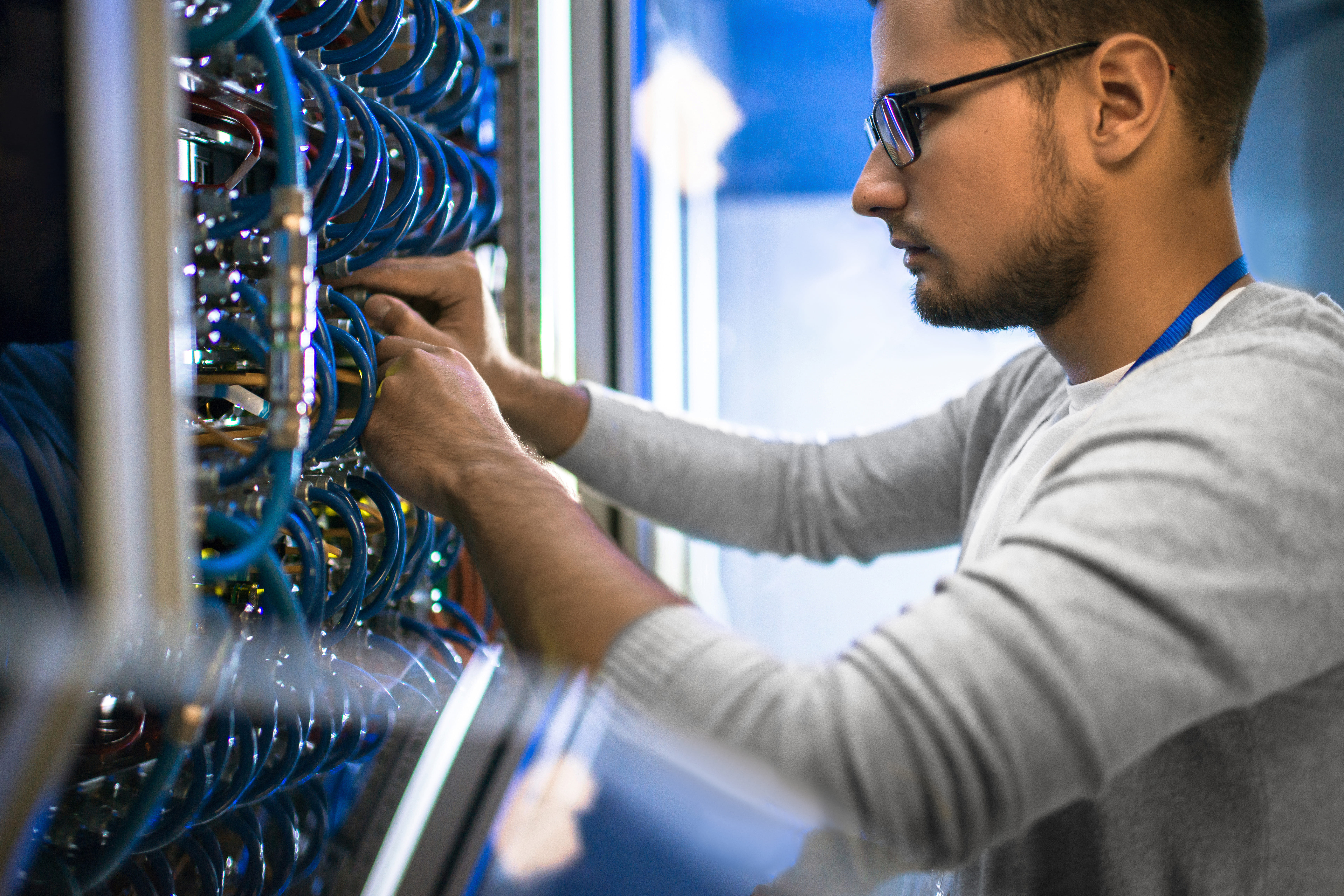 IT technician performing scheduled preventative maintenance on server infrastructure